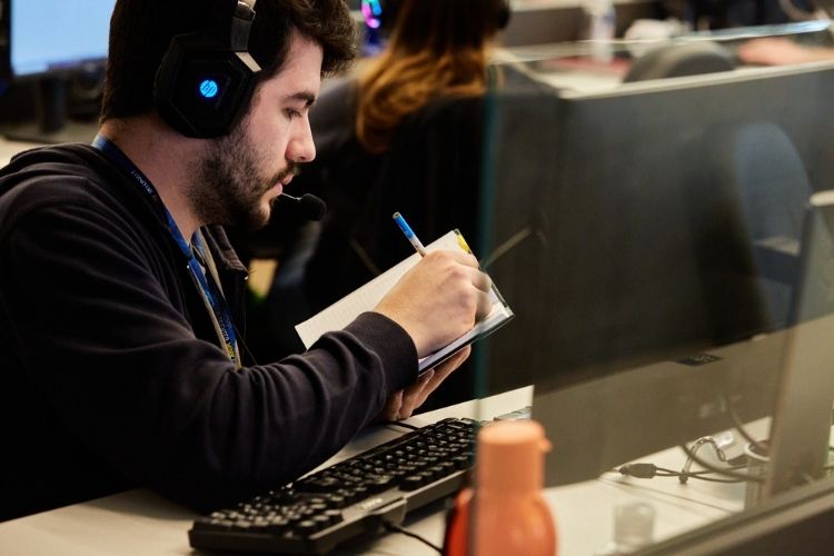 Man making notes in a paper.